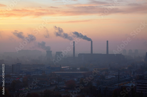 The aerial View of urban fringes at dawn.View over the city rooftops at industrial suburb.Heating Power Plant moderns buildings uptown Industrial cityscape