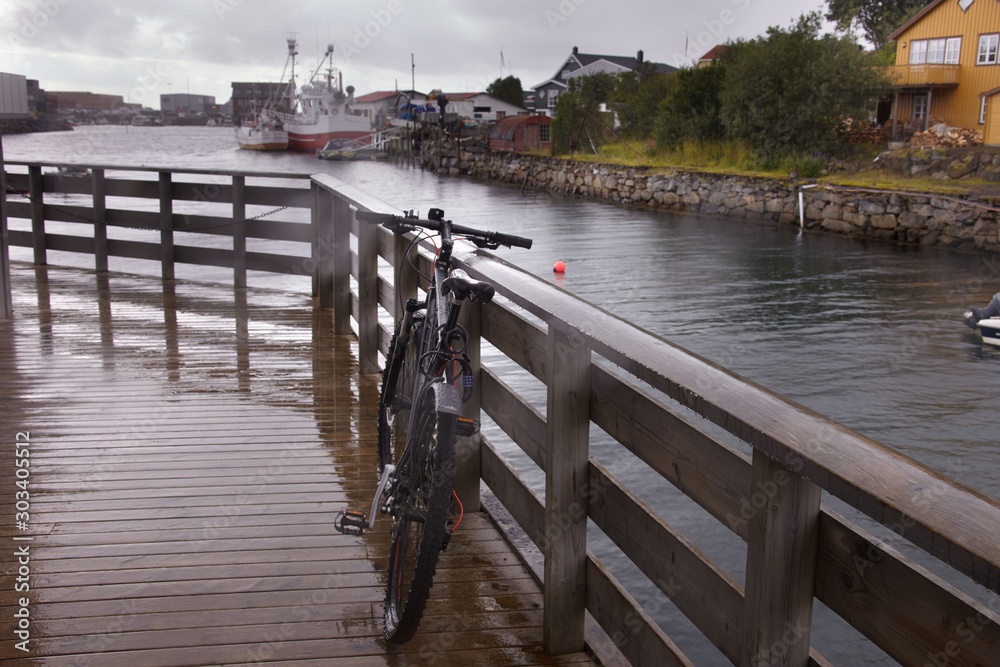 Bicycle on a wooden floor in rainy weather