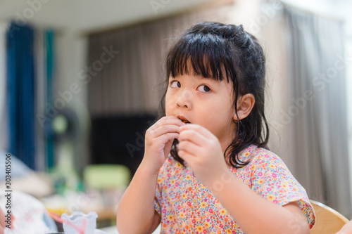 Little asian girl eating crab at home.Little girl enjoying a delicious crab.Seafood and Allergy food concept.