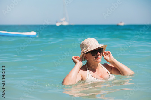 Happy senior woman relaxing in Blue Lagoon. Mediterranean sea in Oludeniz, Turkey.