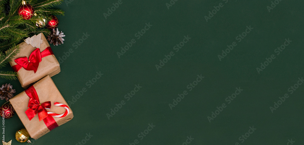 Banner - Christmas and New Year gifts on a green background with copy space with Christmas tree branches. Banner advertising. Banner - Christmas and New Year gifts on a green background with copy space with Christmas tree branches. Banner advertising.