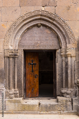 The entrance door to the ancient temple with a cross on the door Goshavank , Armenia