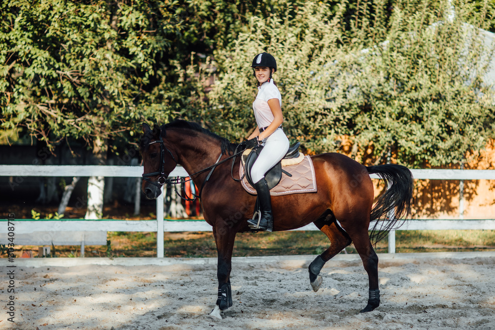 Equestrian sport event at fall with copy space. Young woman riding bay horse on dressage advanced test. Equestrian sport event at fall with copy space. Young woman riding bay horse on dressage advanced test.