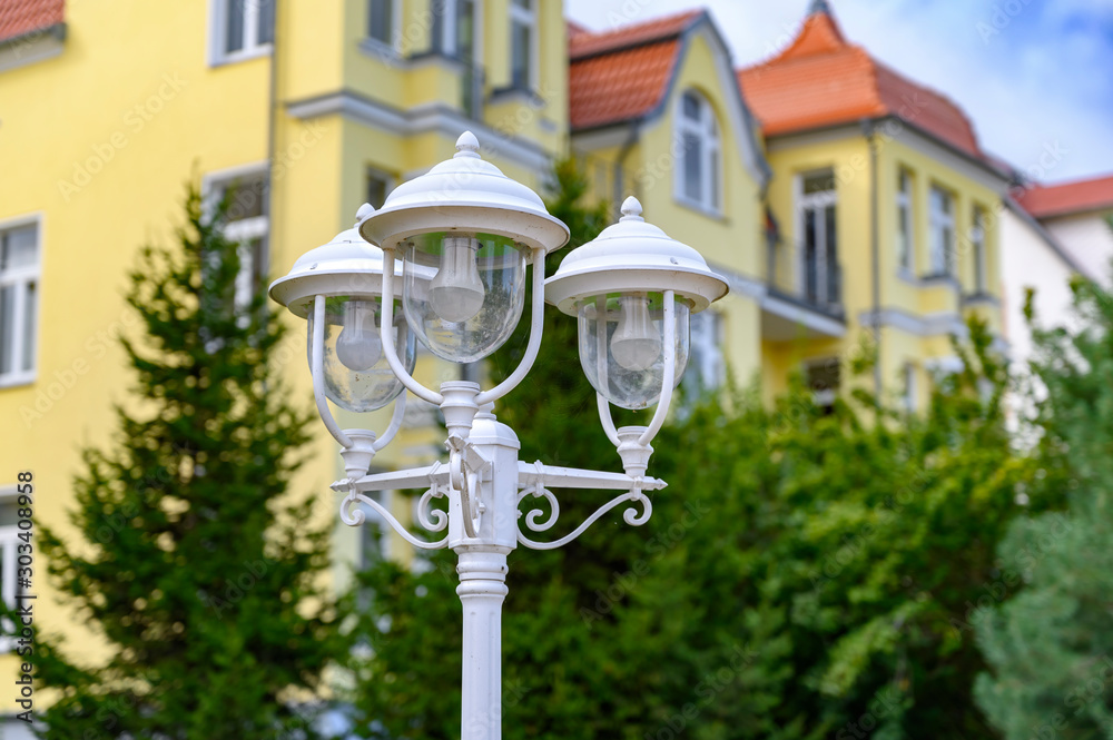 A three-armed lantern in front of a house in Bansin on the island Usedom, Germany.