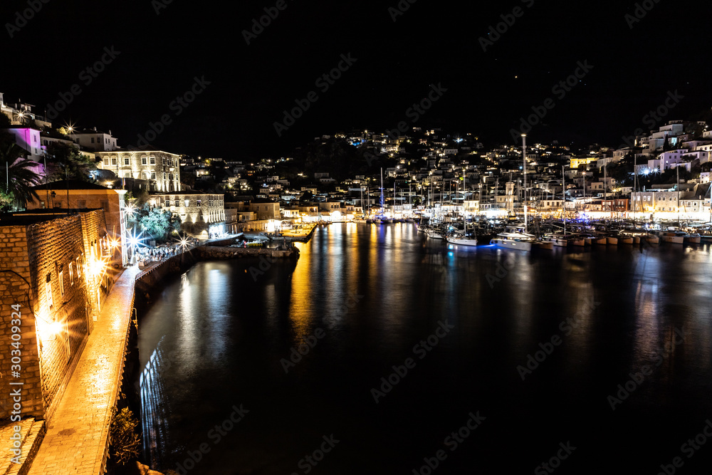 Night lights of Boats and buildings around pier in Hydra Island