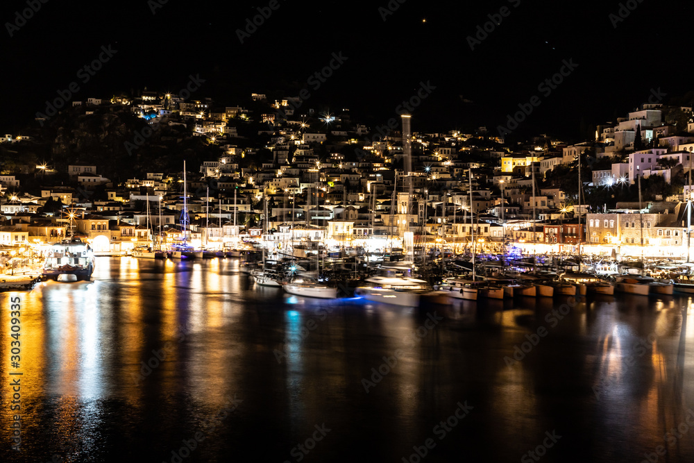 Night lights of Boats and buildings around pier in Hydra Island