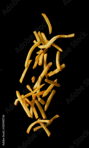 French fries flying in the air isolated on black background