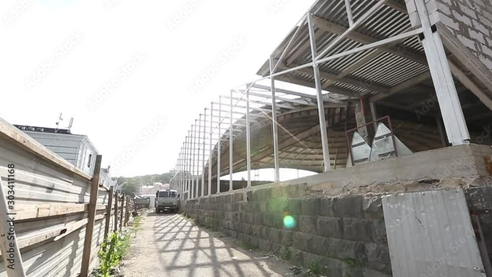 Builders on the construction site on the construction of an entertainment center. Builders on the construction site on the construction of an entertainment center.