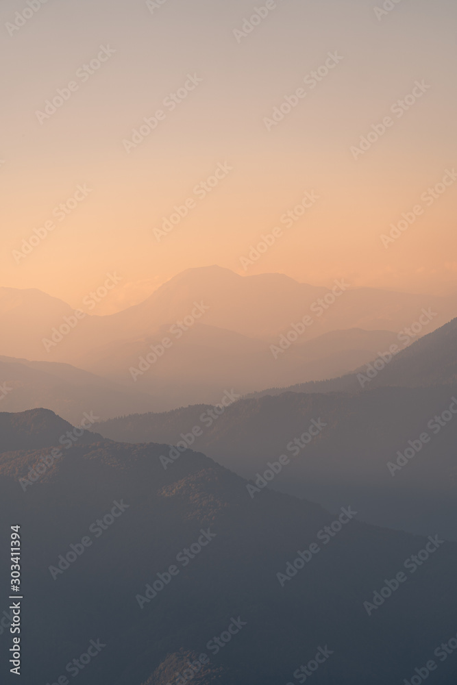 Sunset in the mountains. Mountain view in the fog