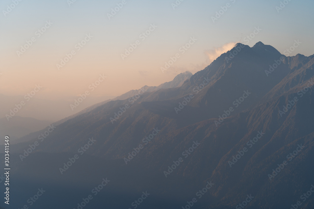 Sunset in the mountains. Mountain view in the fog