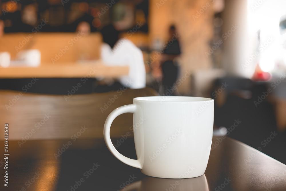 A mug of hot coffee on table in cafe