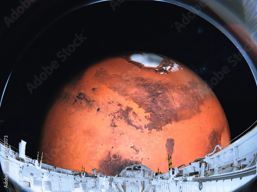 Fototapeta Naklejka Na Ścianę i Meble -  Red Mars planet of solar system in the space near to space shuttle. View from space station porthole. Elements of this image were furnished by NASA