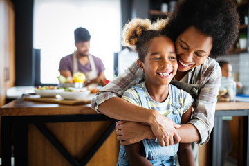 Mother and child having fun preparing healthy food in kitchen
