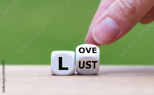Hand turns a dice and changes the word "lust" to "love", or vice versa.