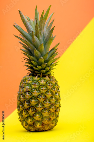 Ripe pineapple fruit on a colored background