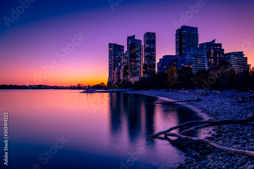 View of Toronto skyline and Lake Ontario from Humber Bay Park area during night time. 