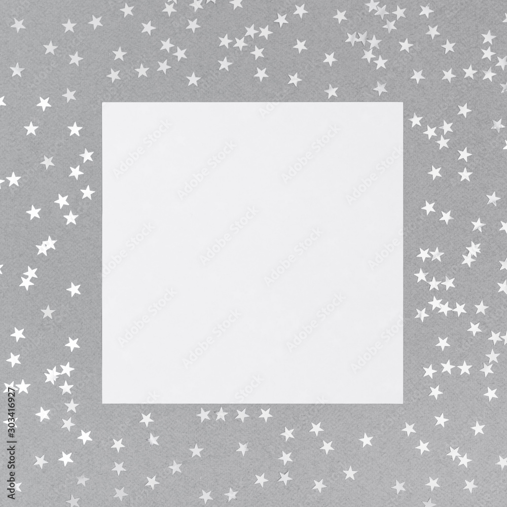 Christmas mockup with silver confetti stars on grey background. Happy New Year. Winter concept. Space for text. Christmas mockup with silver confetti stars on grey background. Happy New Year. Winter concept. Space for text.