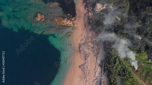 aerial drone 4k view of beautiful beach and wildfire smoke photo