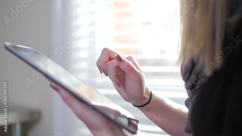 Young Blonde Female Inside Pressing On Her iPad Tablet Close Up