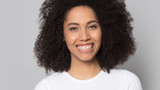 Head shot portrait beautiful African American girl with toothy smile