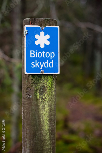 Biotope conservation sign with a protected forestarea photo