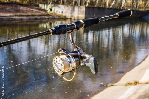 Fishing rod with reel close-up.