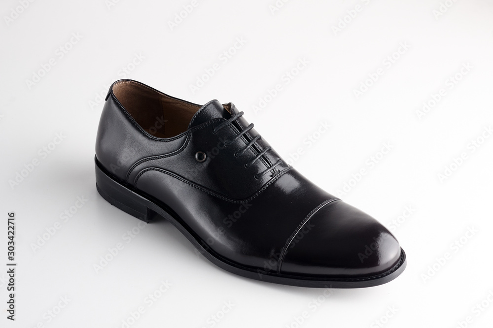 Black man leather shoe with shoelaces on white background Black man leather shoe with shoelaces on white background