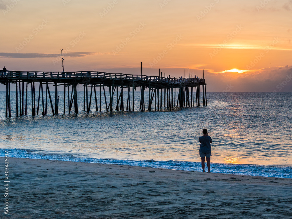 Φωτογραφία Person photographs sunrise over the fishing pier at Outer Banks North Carolina
