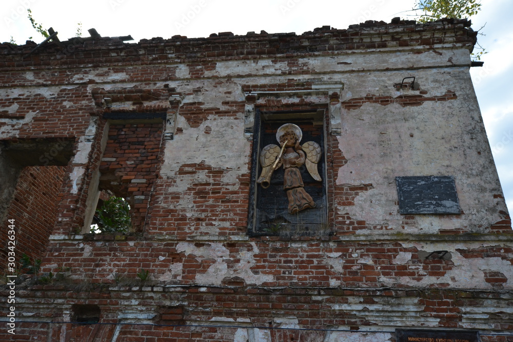 An angel blowing a trumpet: the image in the window of the ruins of the lord's house of the Abamelek estate in Usolye
