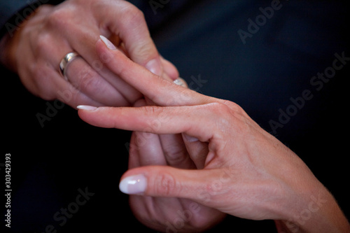 An unrecognizable bride and groom exchanging of the Wedding Rings in church during the christian wedding ceremony 