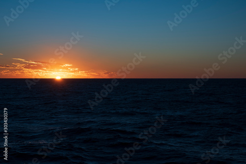 sun set in ocean horizon with orange color