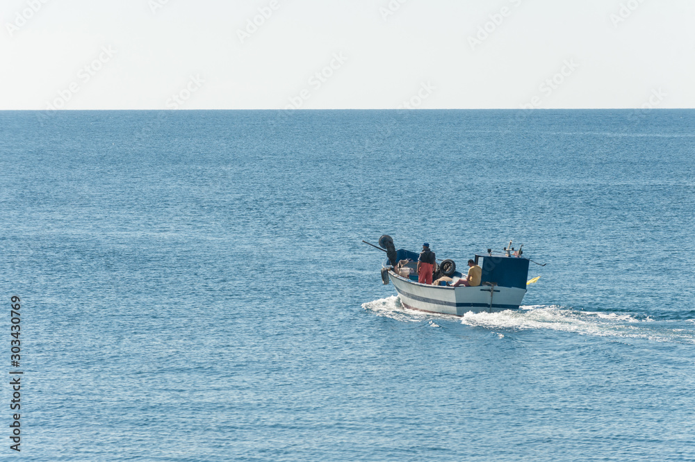 Fisher boat in action at sea