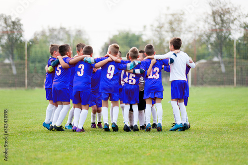 Group of soccer players celebrate the victory. The photo shows the synergy of the participants and the success that each individual has contributed. Concept is applicable to both sports and business