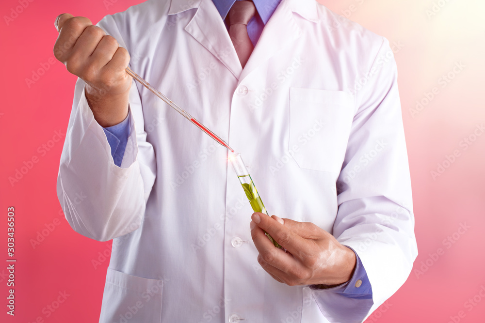 Young doctor with a stethoscope shows tube with blood or plant Young doctor with a stethoscope shows tube with blood or plant