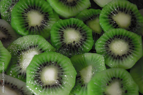 Juicy sliced ​​green kiwi closeup. A lot of kiwi. Texture