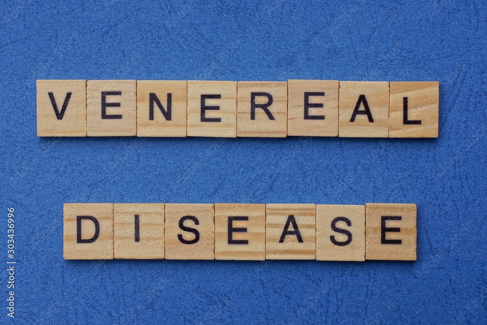 phrase venereal disease made from brown wooden letters lies on a blue table