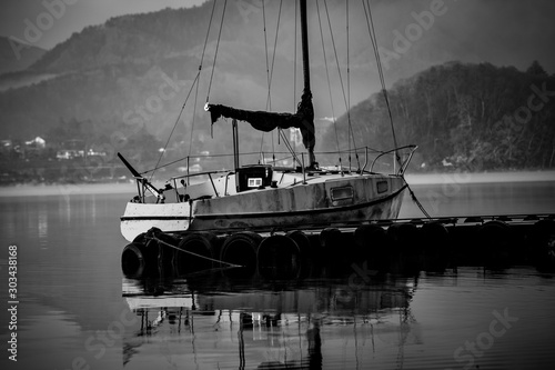 Yatch at pier in lake. black and white photo photo