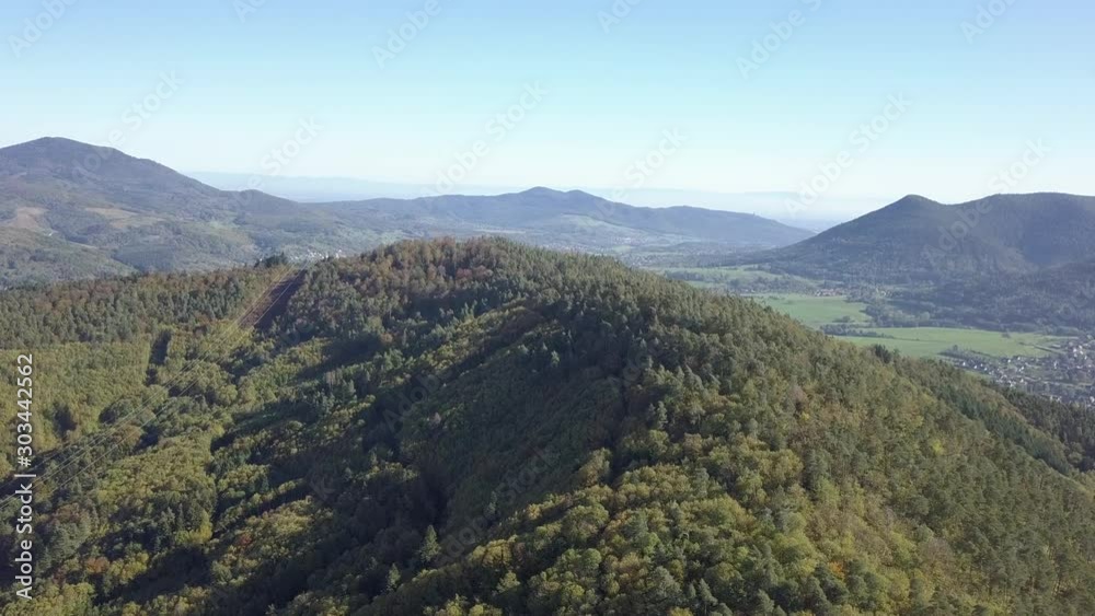 Power lines traverse forested mountainside in the French Vosges