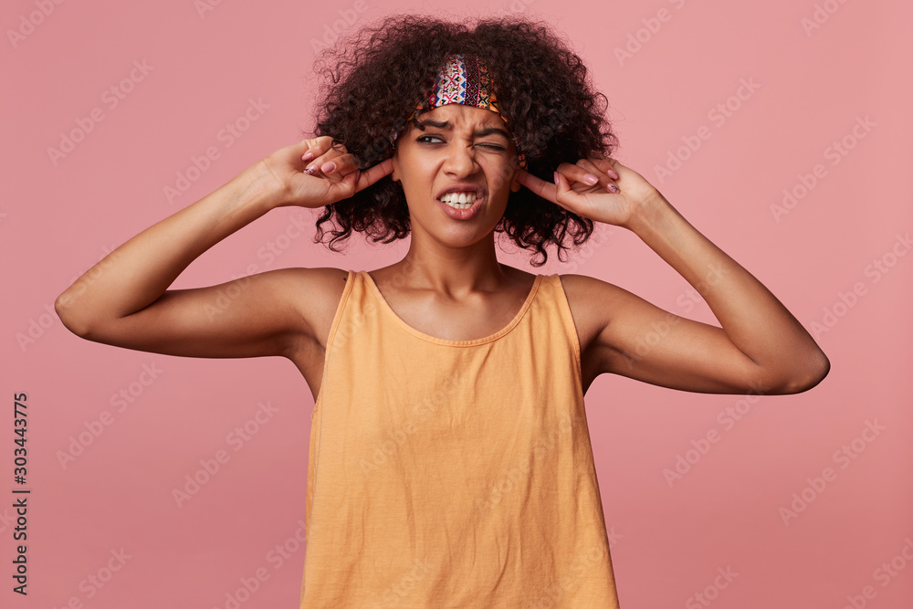 Φωτογραφία Displeased young curly brunette female with dark skin wearing casual hairstyle o