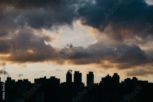 silhouette of skyline with dramatic sky during sunset