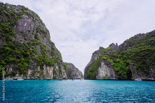Traveling by Thailand. Beautiful seascape with rock and cliff in blue lagoon.