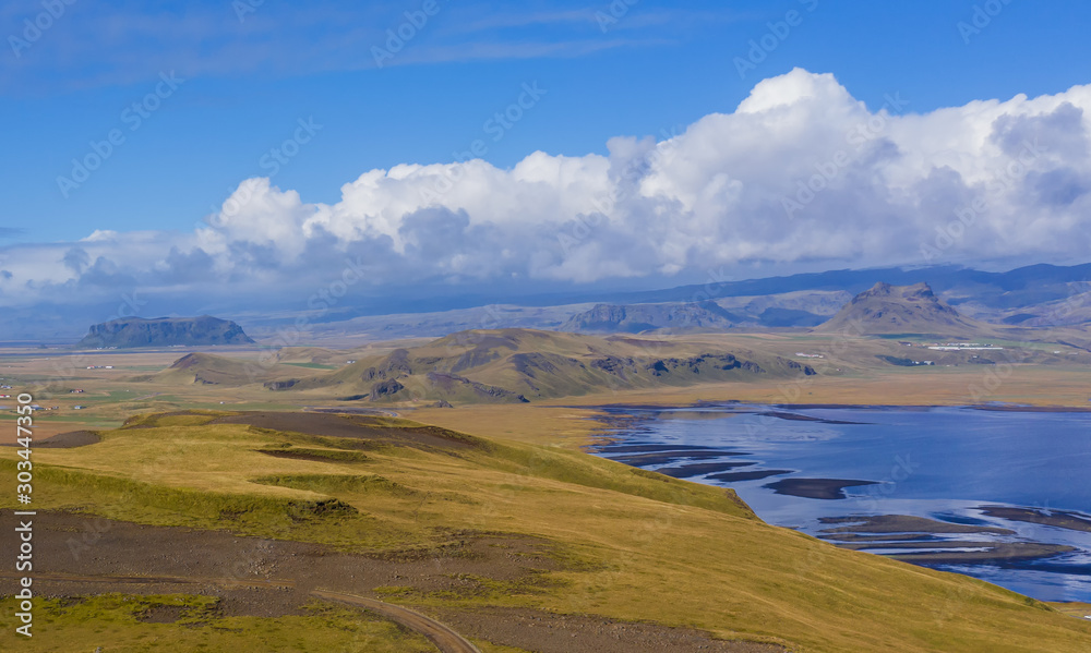 Reynisfjara Beach, Vik Village, Sudurland, Iceland, Europe. Amazing landscape with basalt rock formations and Troll Toes on Black beach Reynisfjara. Aerial drone shot