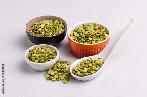 Split dried uncooked peas isolated on white background  close-up  studio shot  soft light  copy space. Christmas dish