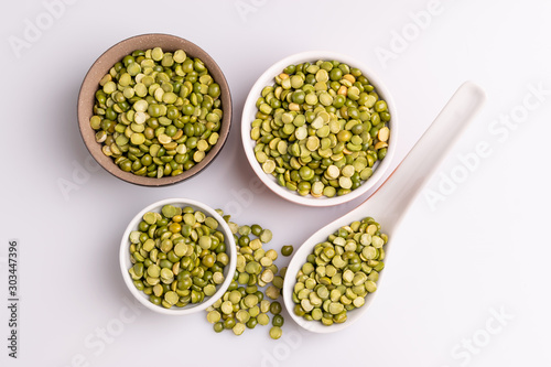 Split dried uncooked peas isolated on white background  close-up  studio shot  soft light  copy space. Christmas dish