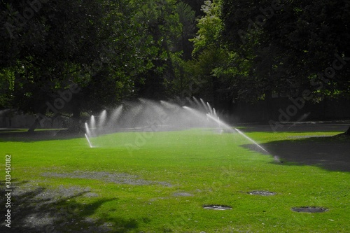 Water irrigation, sprinklers, used to water grass and trees in park