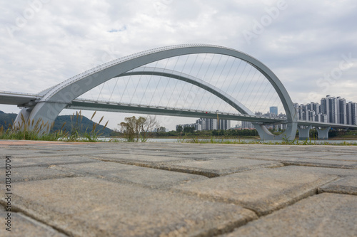 Fototapeta Naklejka Na Ścianę i Meble -  Low angle view of urban curved modern bridge