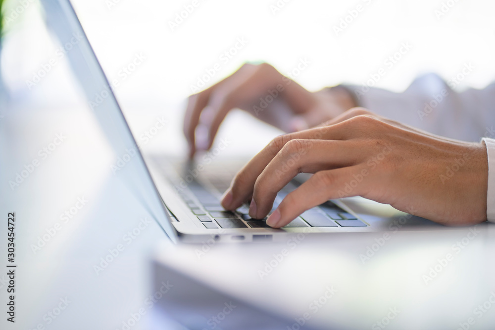 Close up of businessman working on a laptop at the office. Man's hand typing on notebook computer. Close up of businessman working on a laptop at the office. Man's hand typing on notebook computer.