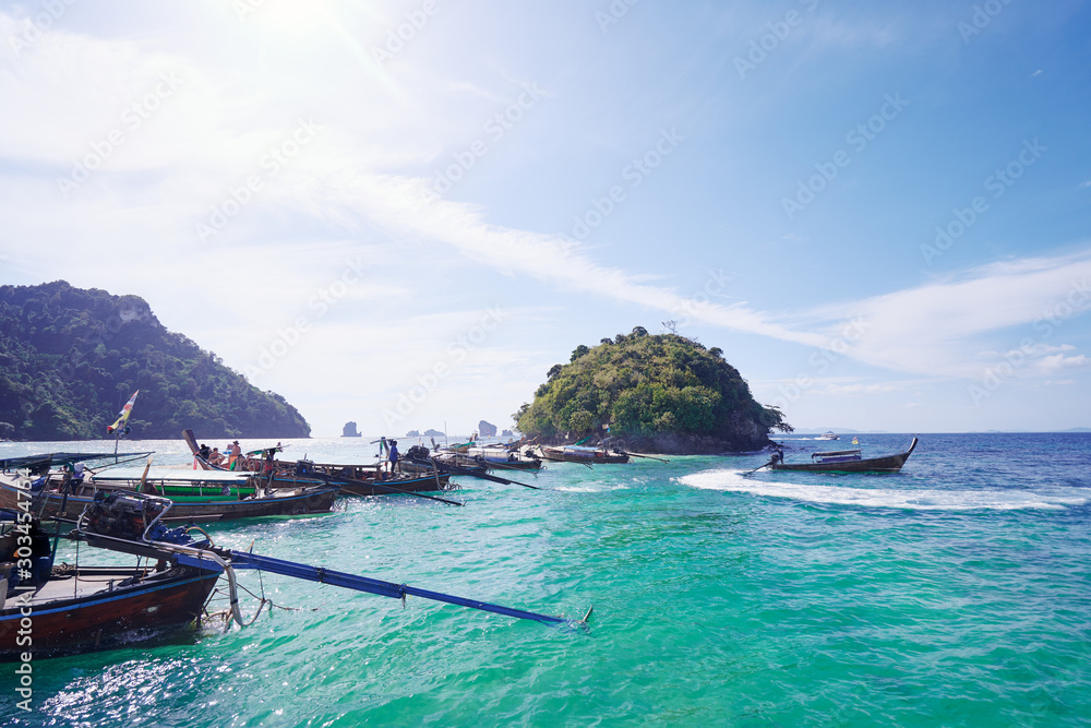 Travel by Thailand. Traditional longtail boats on small tropical island.
