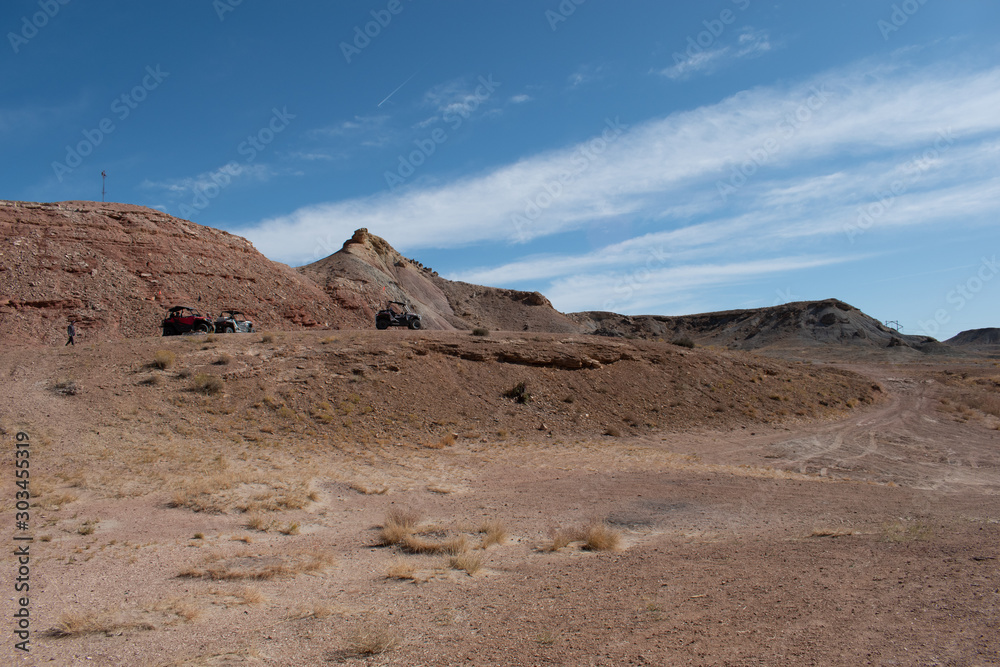 Desert dry land with Four Wheel Drive OHVs on Cliff