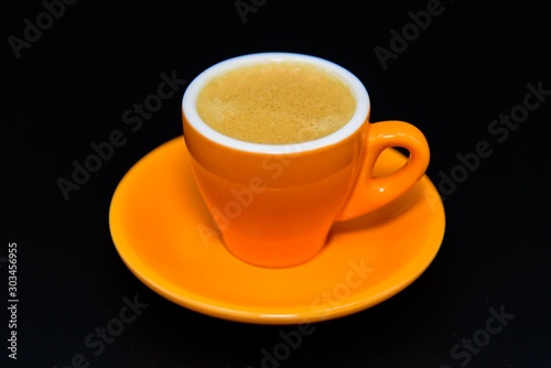 A cup of espresso coffee on black background 